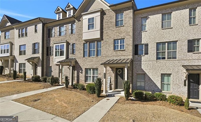 multi unit property featuring a residential view and brick siding