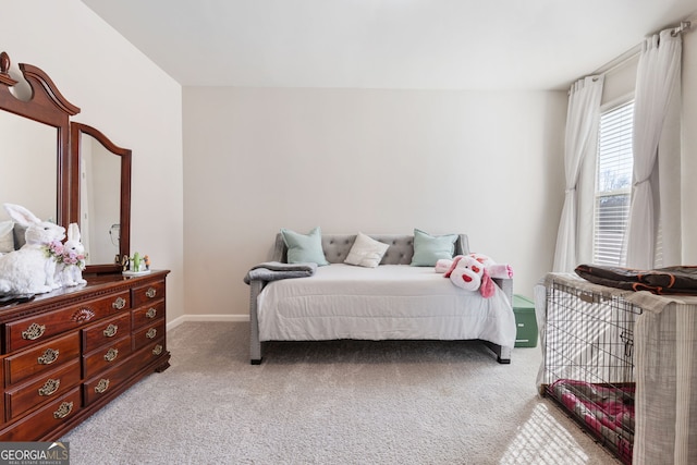 bedroom with light colored carpet and baseboards