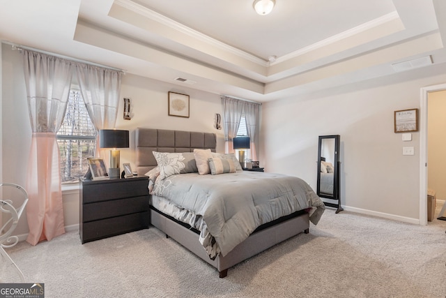 bedroom featuring a raised ceiling, light colored carpet, visible vents, and baseboards