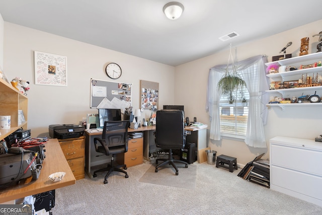 office space with visible vents and light carpet