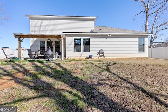 rear view of house with a patio area, a lawn, and fence