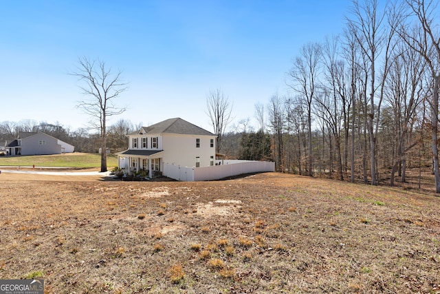 view of property exterior with fence