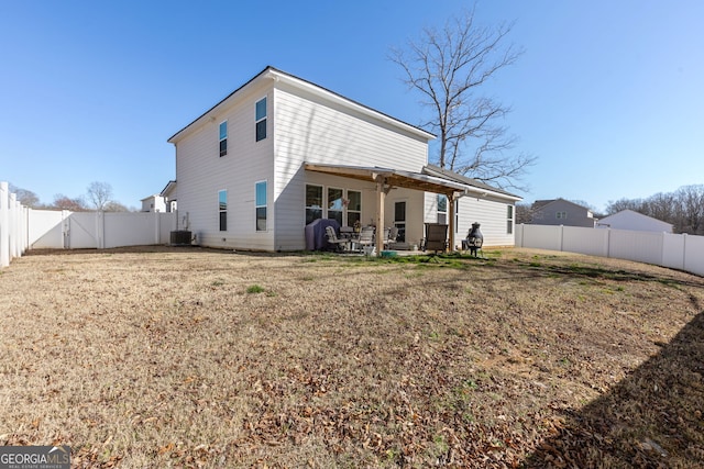 rear view of property with central AC unit, a patio, a yard, and a fenced backyard