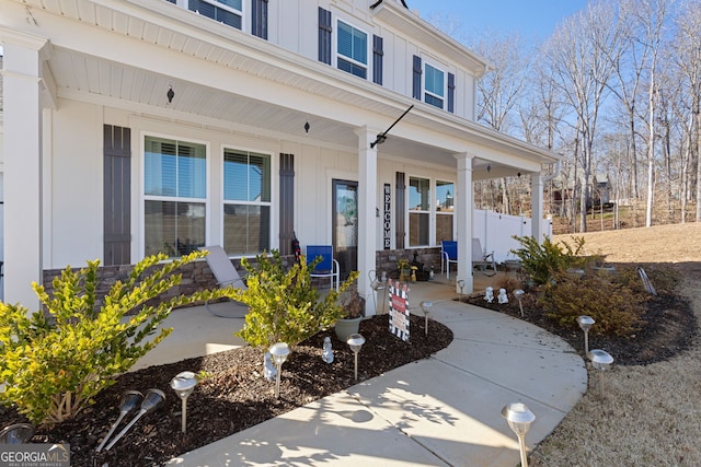entrance to property with a porch and board and batten siding