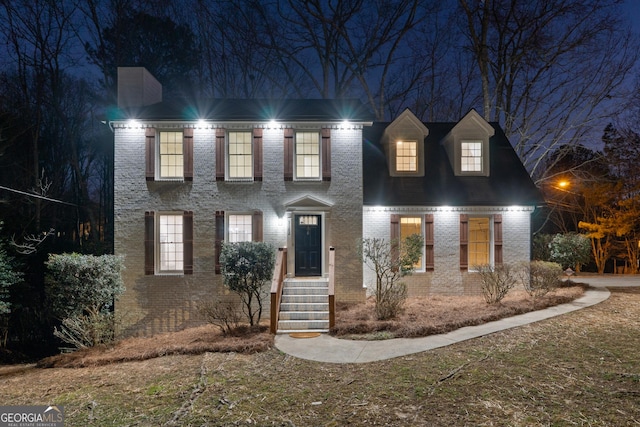 colonial-style house featuring brick siding