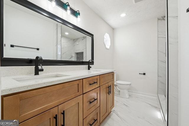 full bath featuring toilet, marble finish floor, a sink, and a marble finish shower