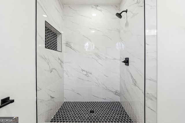 bathroom with a tile shower