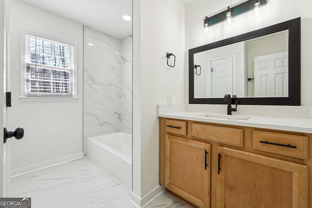 full bath featuring marble finish floor, baseboards, and vanity