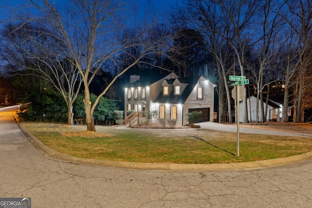 view of front facade with a front yard and concrete driveway