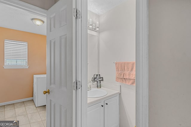 bathroom featuring tile patterned flooring, vanity, and baseboards