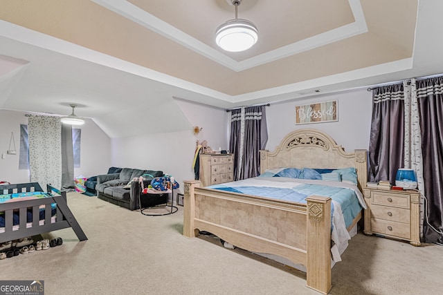 bedroom featuring carpet floors, a tray ceiling, and lofted ceiling