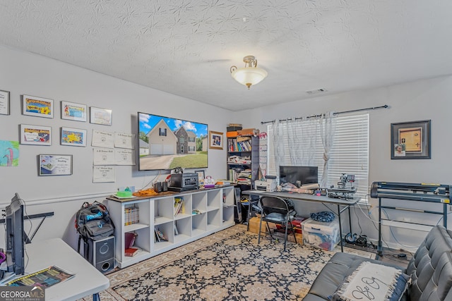 office with a textured ceiling and visible vents