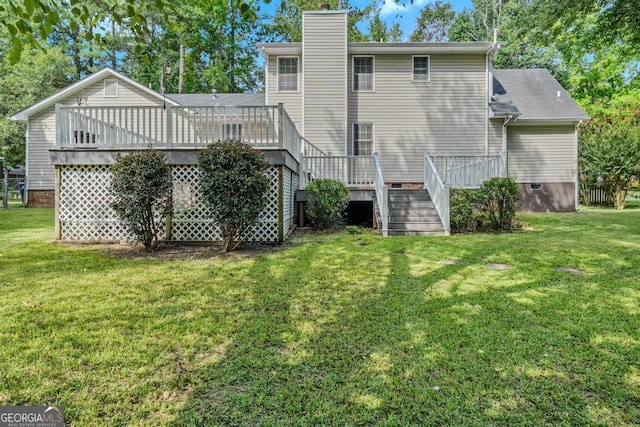 rear view of house with a yard, stairway, a chimney, and a wooden deck