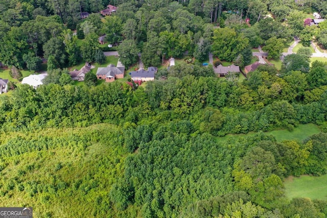 birds eye view of property featuring a forest view