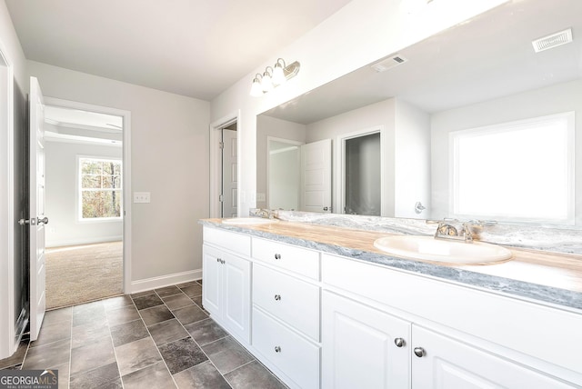 full bath with double vanity, visible vents, and a sink