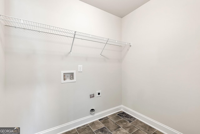 clothes washing area featuring laundry area, washer hookup, electric dryer hookup, and baseboards