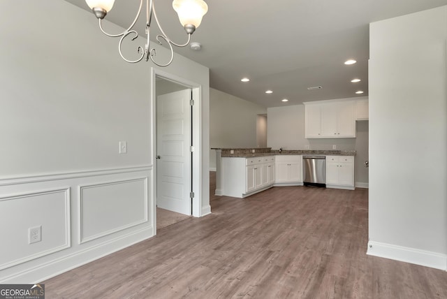 kitchen with a notable chandelier, recessed lighting, white cabinetry, wood finished floors, and dishwasher