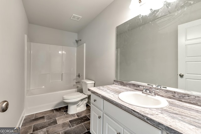 bathroom featuring visible vents, shower / washtub combination, vanity, and toilet