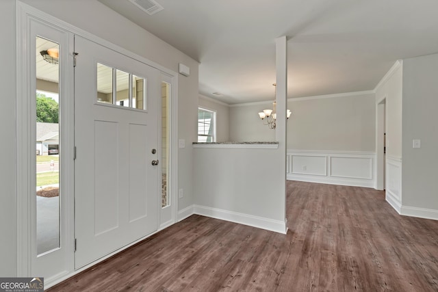 entrance foyer featuring dark wood-style floors, wainscoting, visible vents, and crown molding