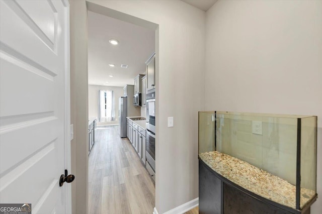 interior space featuring light wood-style floors, visible vents, baseboards, and recessed lighting