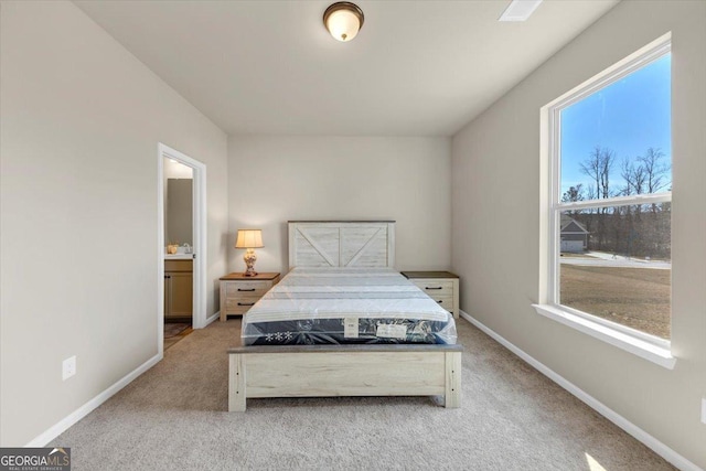 bedroom with multiple windows, baseboards, and light colored carpet