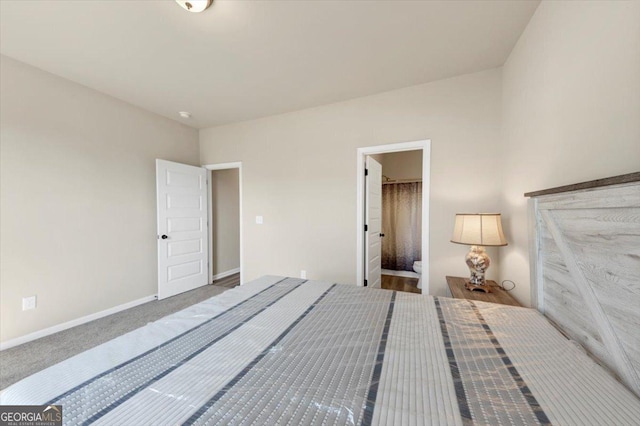 unfurnished bedroom featuring ensuite bathroom, carpet, and baseboards