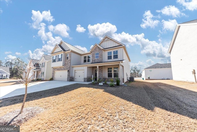 view of front of home with a garage, board and batten siding, concrete driveway, stone siding, and central AC