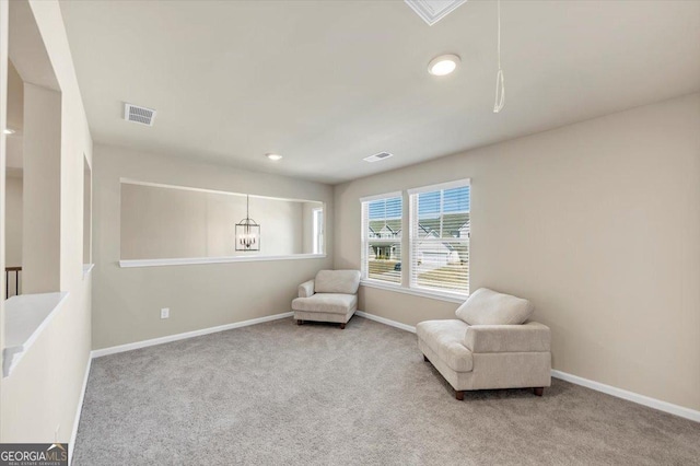 living area featuring baseboards, visible vents, and carpet flooring