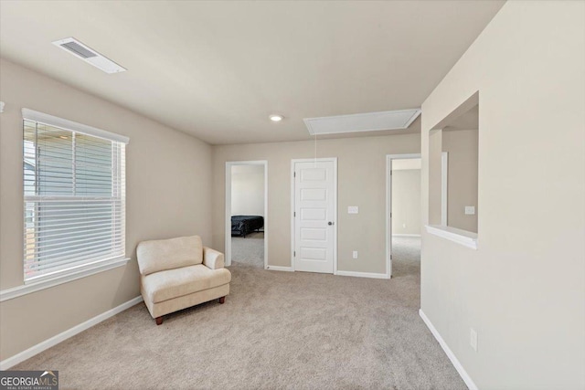 sitting room featuring attic access, carpet, visible vents, and baseboards