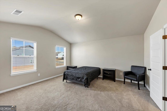 carpeted bedroom with vaulted ceiling, visible vents, and baseboards