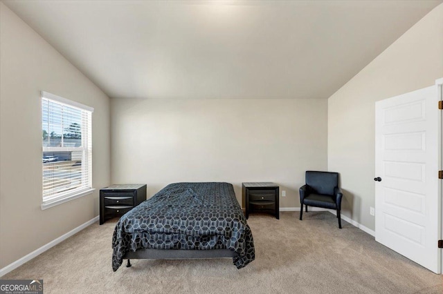 bedroom with baseboards, vaulted ceiling, and carpet flooring