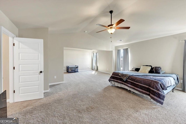 bedroom featuring vaulted ceiling, carpet flooring, visible vents, and baseboards