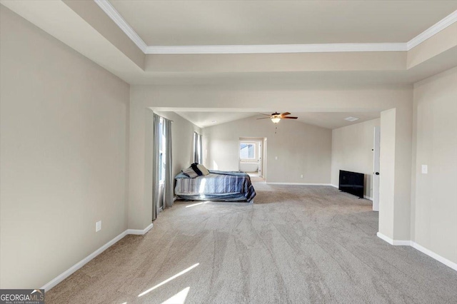 unfurnished bedroom featuring carpet, crown molding, lofted ceiling, ceiling fan, and baseboards