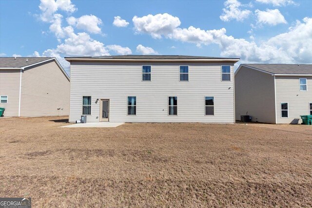 rear view of house featuring cooling unit and a patio