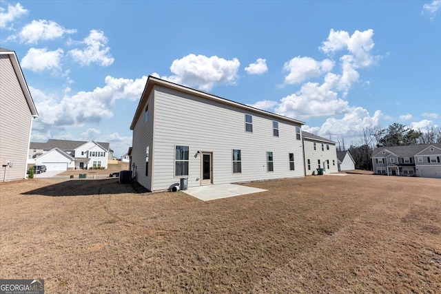 rear view of house featuring a yard, a patio area, and a residential view