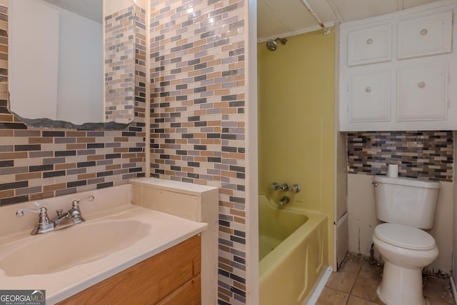 bathroom with toilet, washtub / shower combination, tile patterned flooring, decorative backsplash, and tile walls