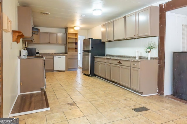 kitchen with stove, freestanding refrigerator, white dishwasher, gray cabinetry, and exhaust hood