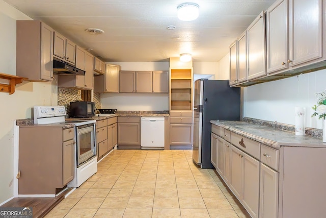 kitchen featuring light tile patterned floors, visible vents, decorative backsplash, white appliances, and under cabinet range hood