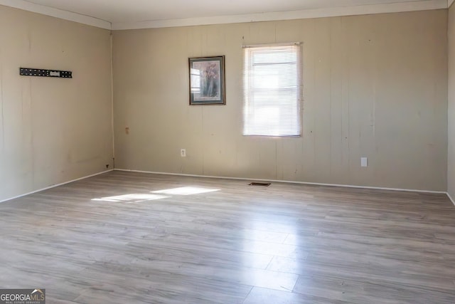 empty room with visible vents and wood finished floors