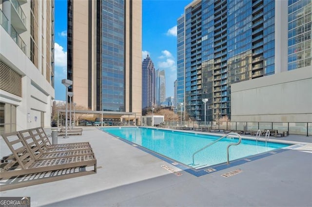 pool with a patio and a city view