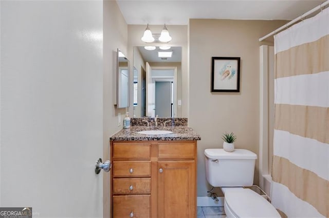 bathroom featuring toilet, tile patterned floors, shower / tub combo, and vanity