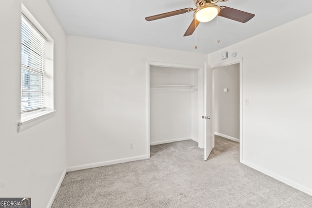 unfurnished bedroom with carpet floors, a ceiling fan, baseboards, and a closet