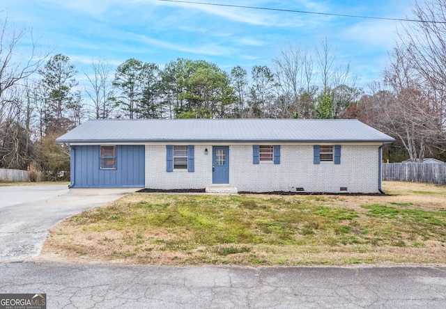 single story home featuring brick siding, crawl space, metal roof, fence, and a front lawn