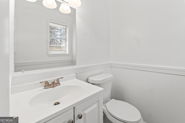 bathroom featuring toilet and vanity