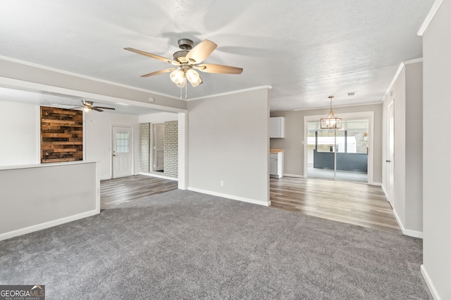 unfurnished living room featuring carpet, crown molding, baseboards, and ceiling fan