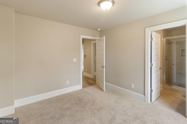 unfurnished bedroom with carpet flooring and baseboards