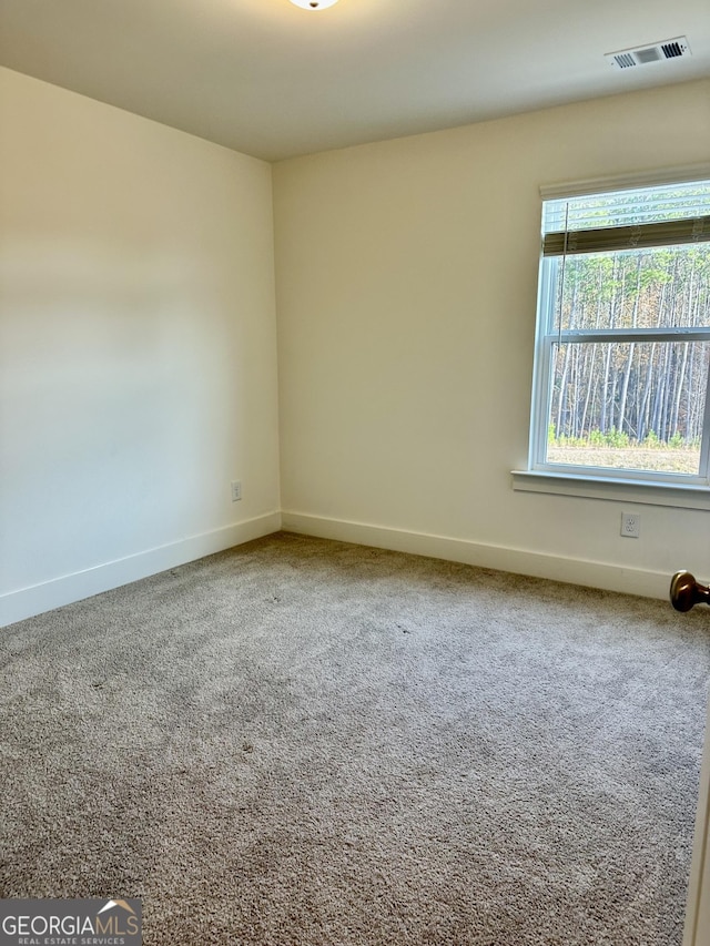 carpeted empty room with baseboards and visible vents