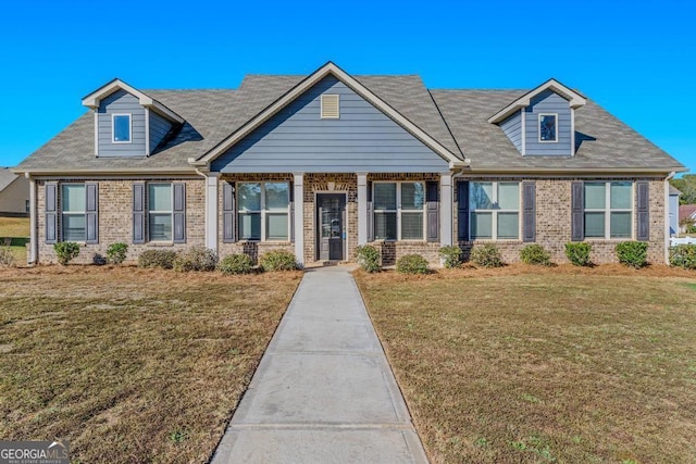 view of front facade featuring a front yard and brick siding