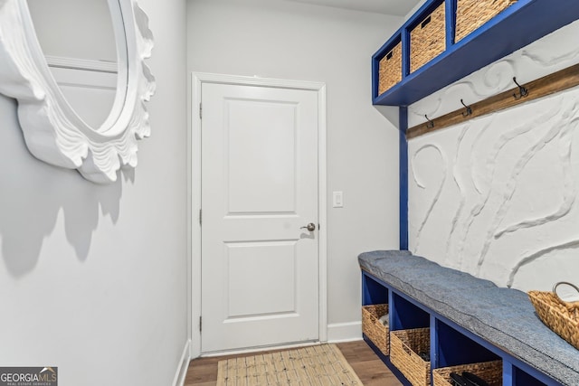 mudroom featuring wood finished floors and baseboards