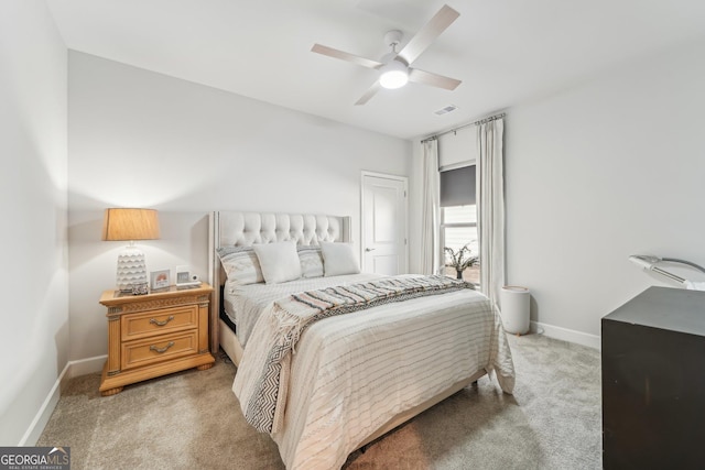 bedroom featuring a ceiling fan, light colored carpet, and baseboards